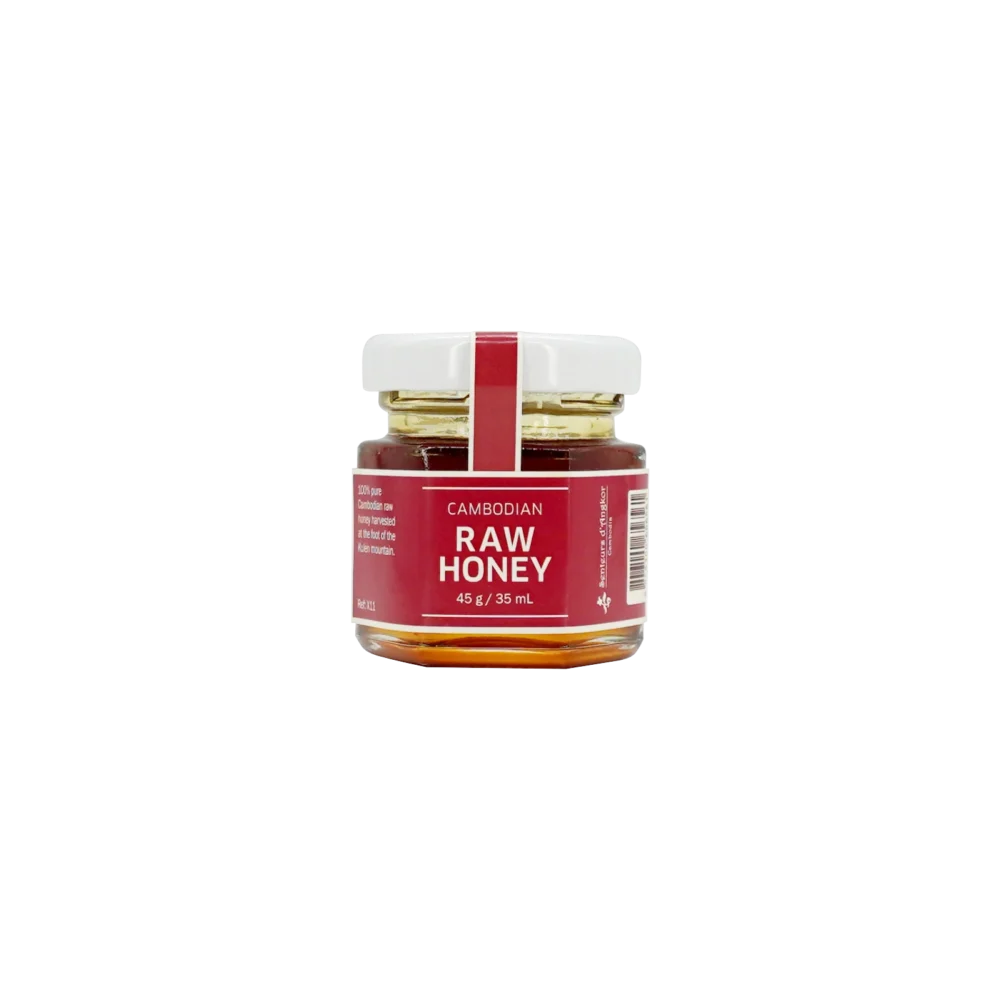 Cambodian raw honey in small hexagonal glass jar, front