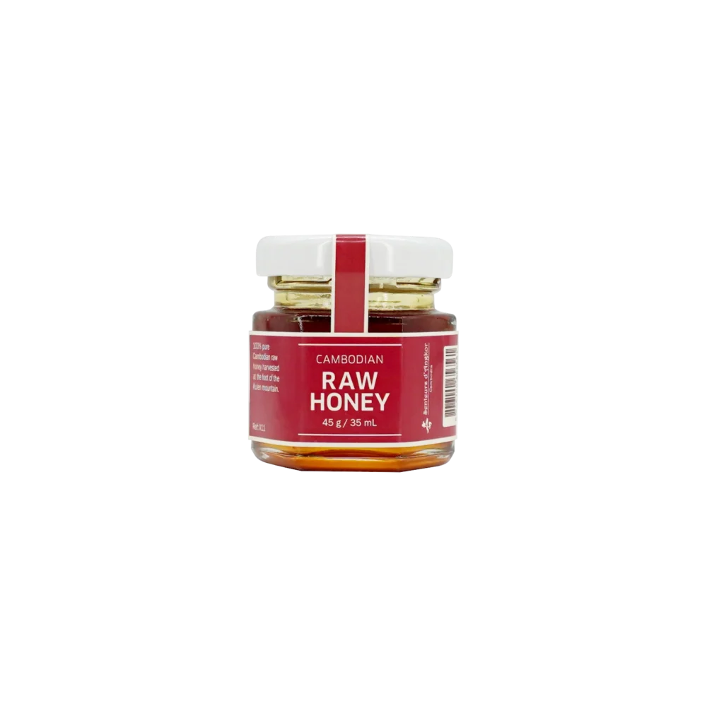 Cambodian raw honey in small hexagonal glass jar, front