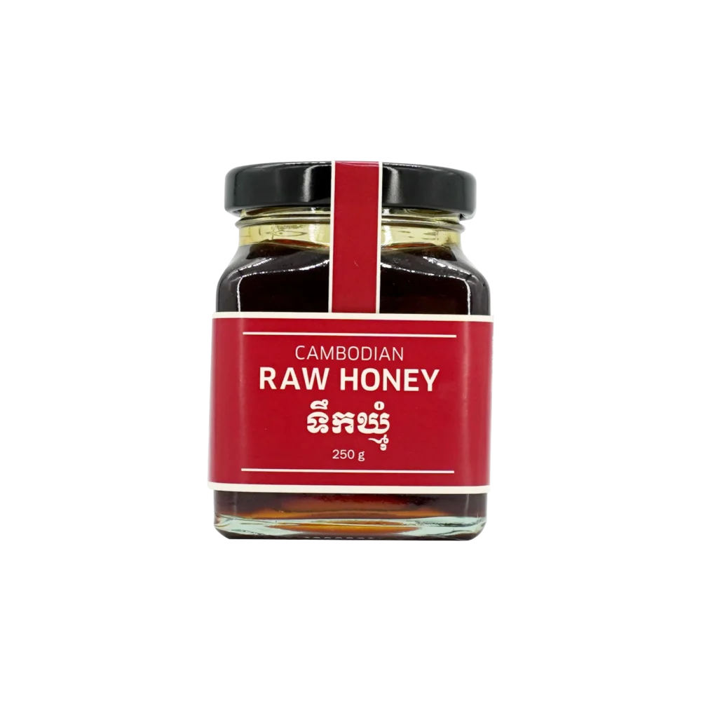 Raw honey in big square glass jar, front