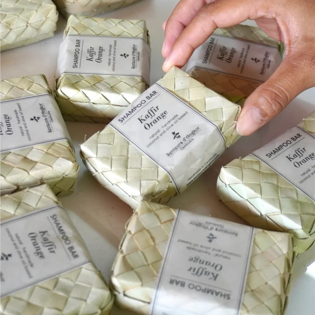Shampoo soap being packed by hand one by one.
