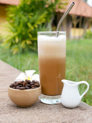 Iced coffee from Cambodia's Mondulkiri province in a glass with a stainless steel straw