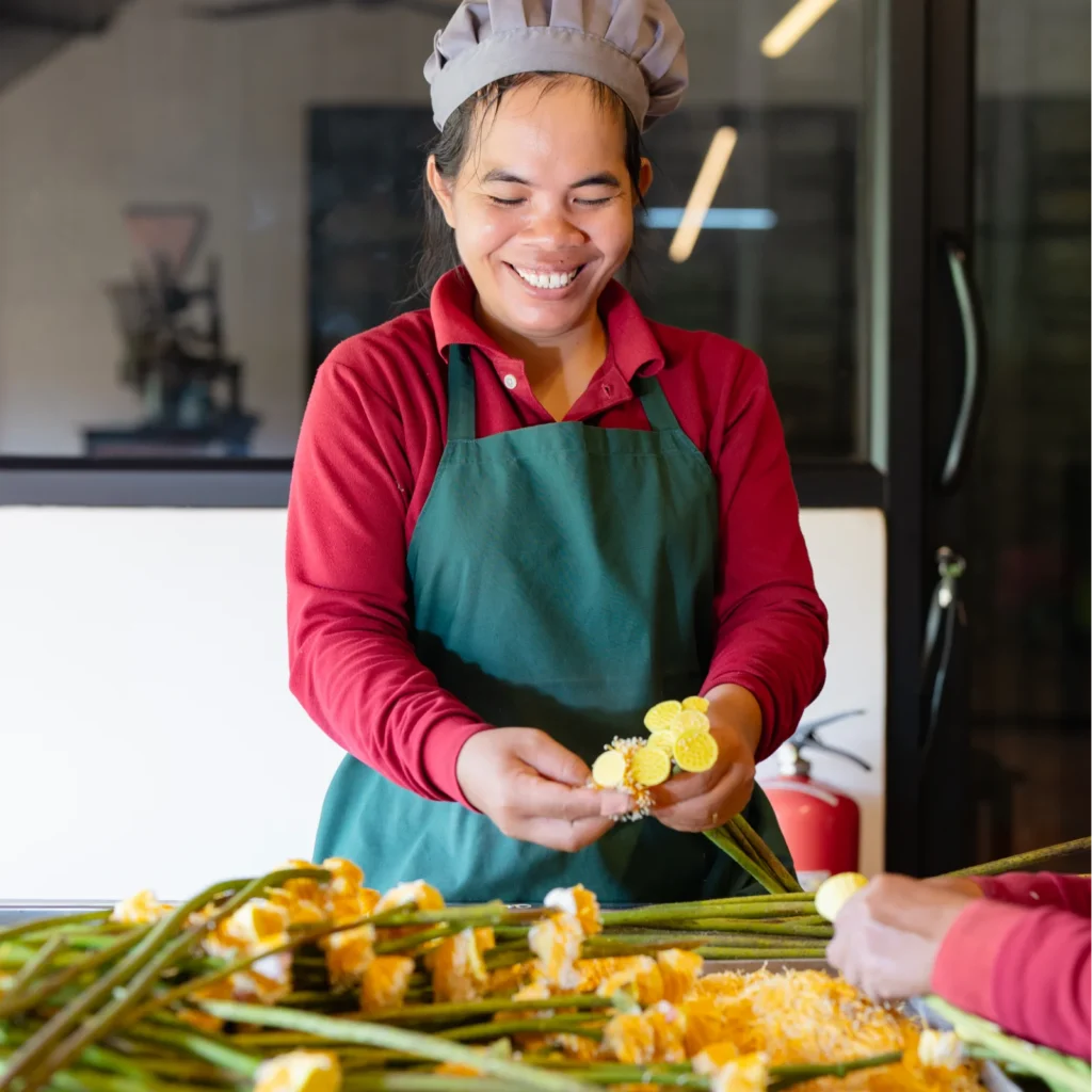 Artisan separates the stamen from the lotus flower.