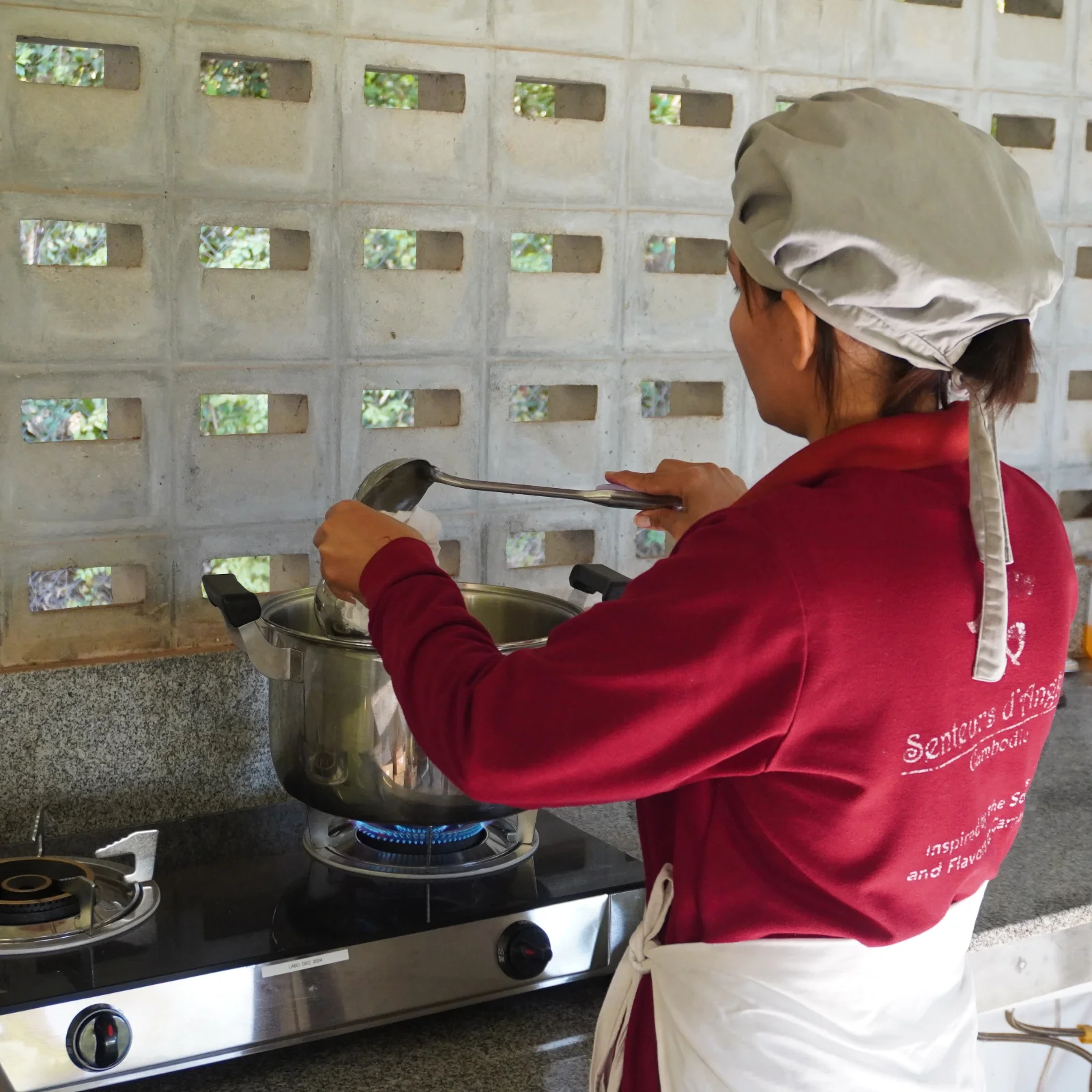Artisan preparing the Angkor balm mixture.