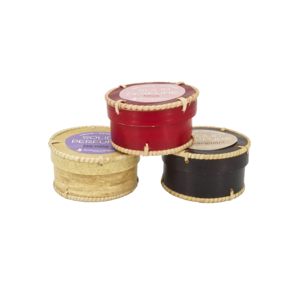 Solid perfume in an aluminium container packaged in natural palm wood, all stacked