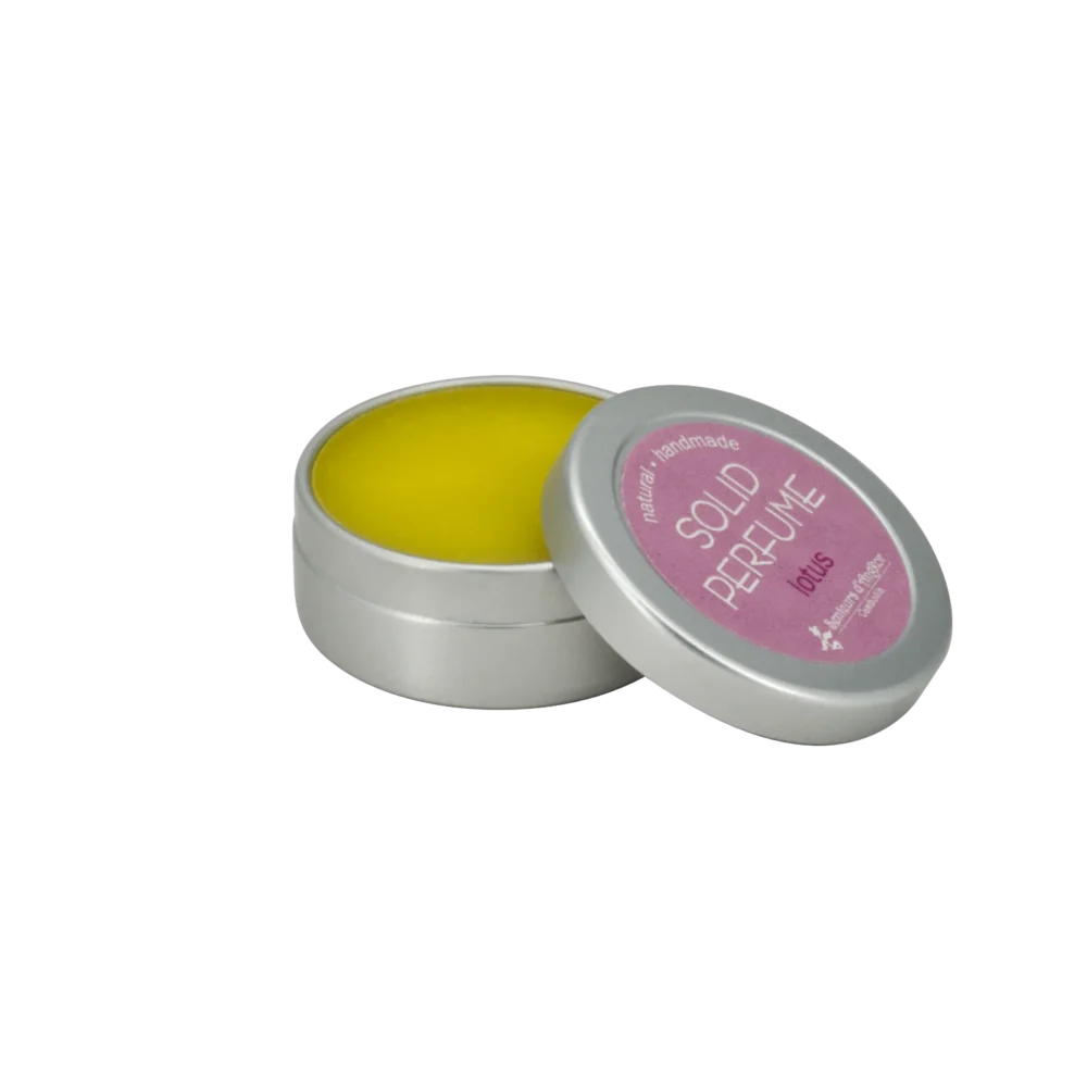 Solid perfume in an aluminium container (opened), lotus scent