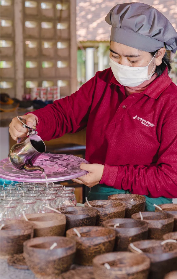 Artisan cleaning the candle before packaging
