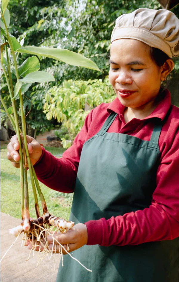 Artisan opening a big glass jar of spices for us to enjoy its smell.