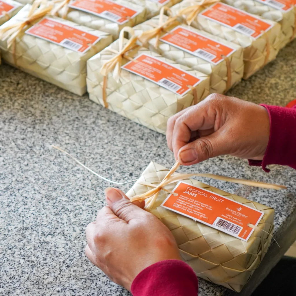 Artisan seals a set of tropical fruit jam made from coconut fiber.