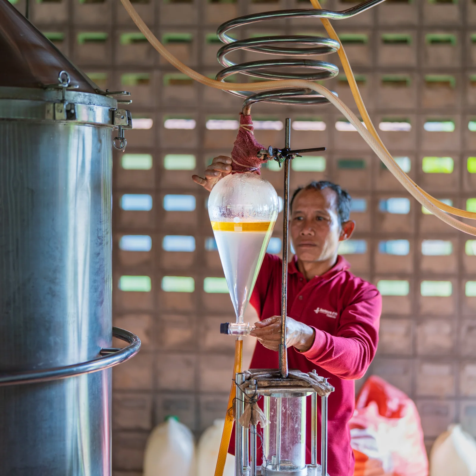 Artisan checking on the essential oil making.