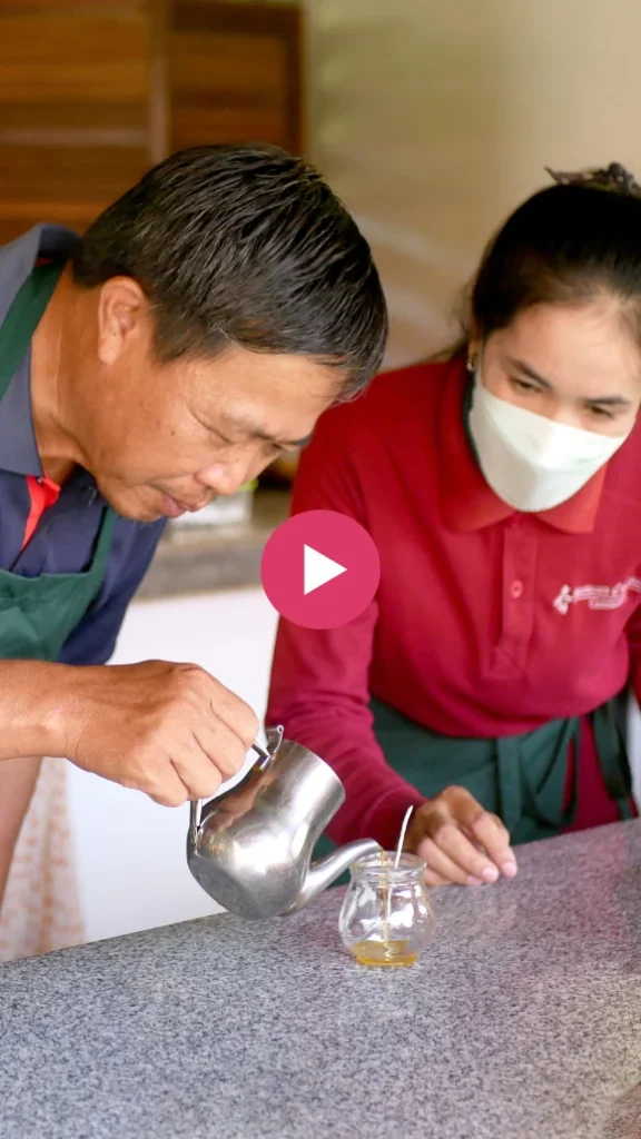 Video's thumbnail where a Cambodian man is learning how to make a candle.