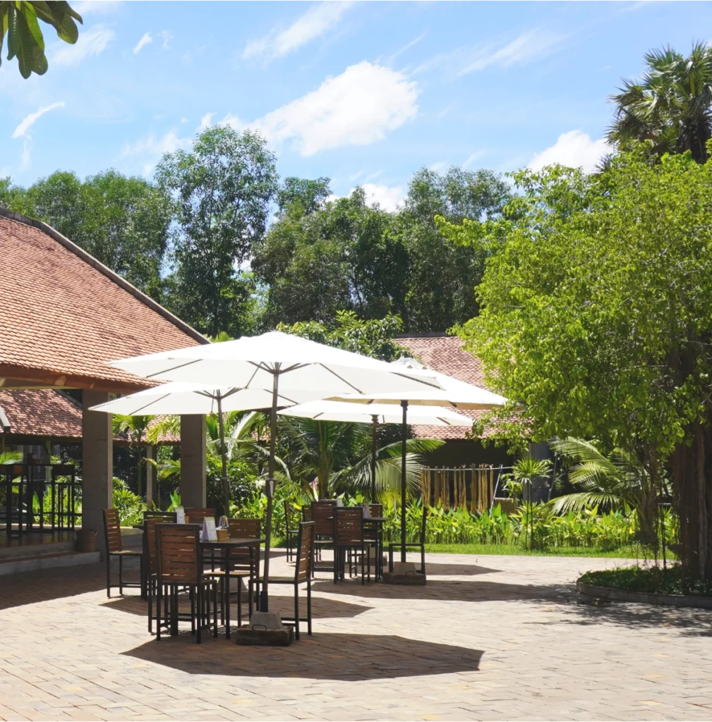 View of the Café of Senteurs d'Angkor surrounded by a tropical garden and its workshops