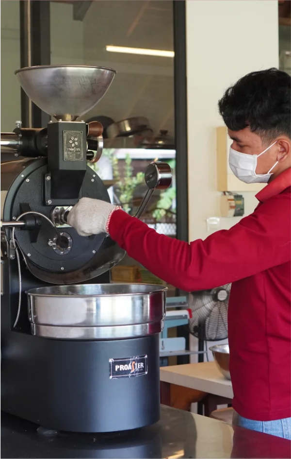 Artisan setting up tte coffee roasting machine